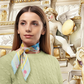 Woman wearing a colourful scarf with an angel statue in Buxton Opera House